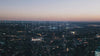 AI letters set against a backdrop of a modern city with skyscrapers, captured during the evening skyline.