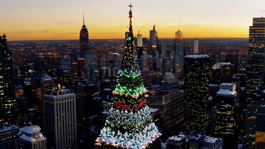 A stunning aerial perspective of a city at dusk, showcasing the twinkling Christmas tree lights blending with the holiday atmosphere.