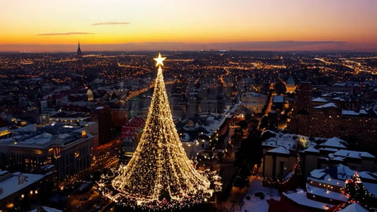 An enchanting aerial view of a city during Christmas evening, with street lights and Christmas decorations glowing in the twilight.