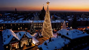 An idyllic cityscape at sunset with a Christmas tree brightly lit, as the last rays of sun blend beautifully with the city�s holiday lights.