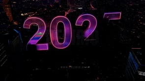 "Futuristic city skyline adorned with neon ""2025"" letters, signaling the opening of the New Year in a bold display."