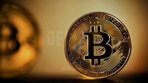 Gold crypto coin spinning with Bitcoin bulls on the background, highlighting Bitcoin�s potential in a bullish market.