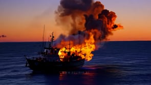 A ship ablaze on the water as the sunset fades, the vibrant flames contrasting with the soft evening sky.