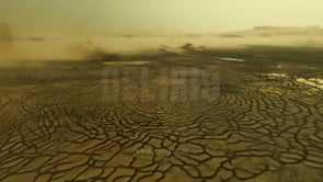 Aerial view of drought-stricken land, cracked surface, environmental impact, showcasing the devastating effects of water scarcity, desertification, and climate change on the landscape.