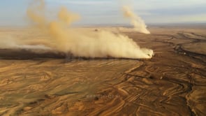 Aerial view of an expansive dry desert with a cracked landscape, emphasizing the harsh environmental conditions caused by drought and land degradation.