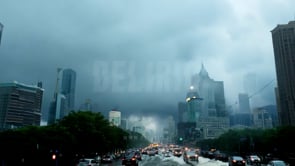 City experiencing massive flooding, submerging cars in downtown areas, highlighting the environmental catastrophe caused by rising waters and severe weather events.