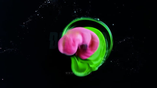 A dynamic green and pink ink explosion concept for an energetic and artistic design.