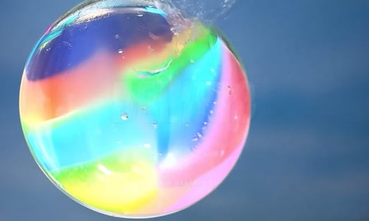 Close-up view of bubbles interacting on a colorful surface, with a focus on healthcare and wellness themes.