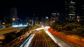 Aerial view of a night city time-lapse, with vibrant light motion and dynamic urban energy.