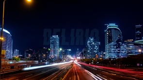 Modern cityscape scene with wide-angle visuals of lights and motion blurs in a vibrant urban environment.