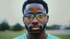 A man wearing AI-powered augmented reality glasses in a close-up view, demonstrating a futuristic tech concept.