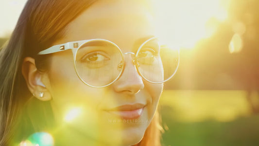 A woman wearing augmented reality smart glasses in a close-up, with motion graphics effects illustrating futuristic tech.