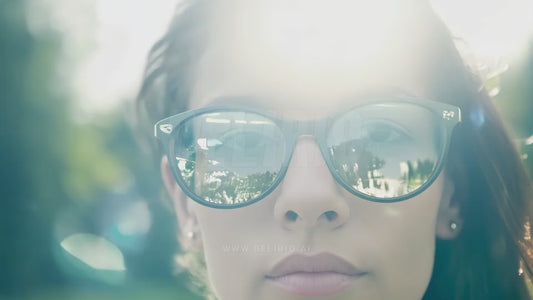 Motion graphics animation features a white woman wearing augmented reality glasses in a close-up shot, merging design and tech.