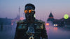 A Black man dressed in an elaborate steampunk cosplay costume, standing in a rich, fantastical world with a blurred, otherworldly backdrop, highlighting the fusion of vintage and futuristic aesthetics.