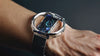 A close-up of a futuristic smartwatch emitting holograms, representing modern wearable tech design.